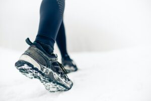 Hiking or walking shoes on snow, winter mountains