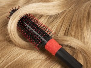 Long blond human hair with a comb