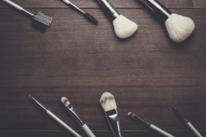 make-up brushes on wooden background