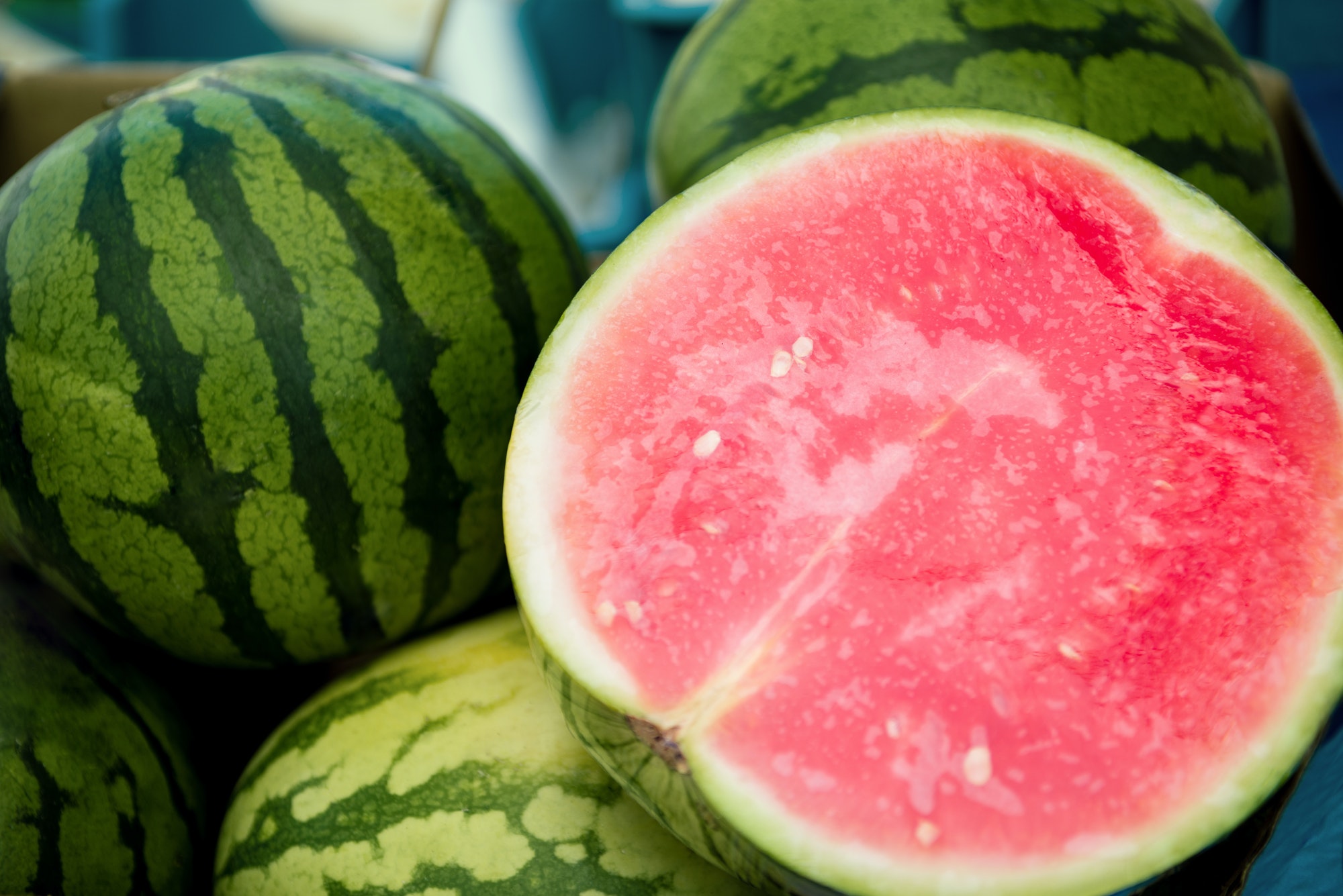 close up view of half of watermelon and watermelons