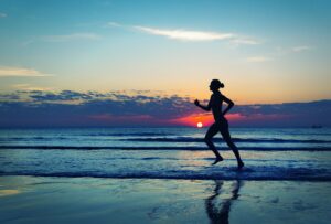Girl runing along the sea coast
